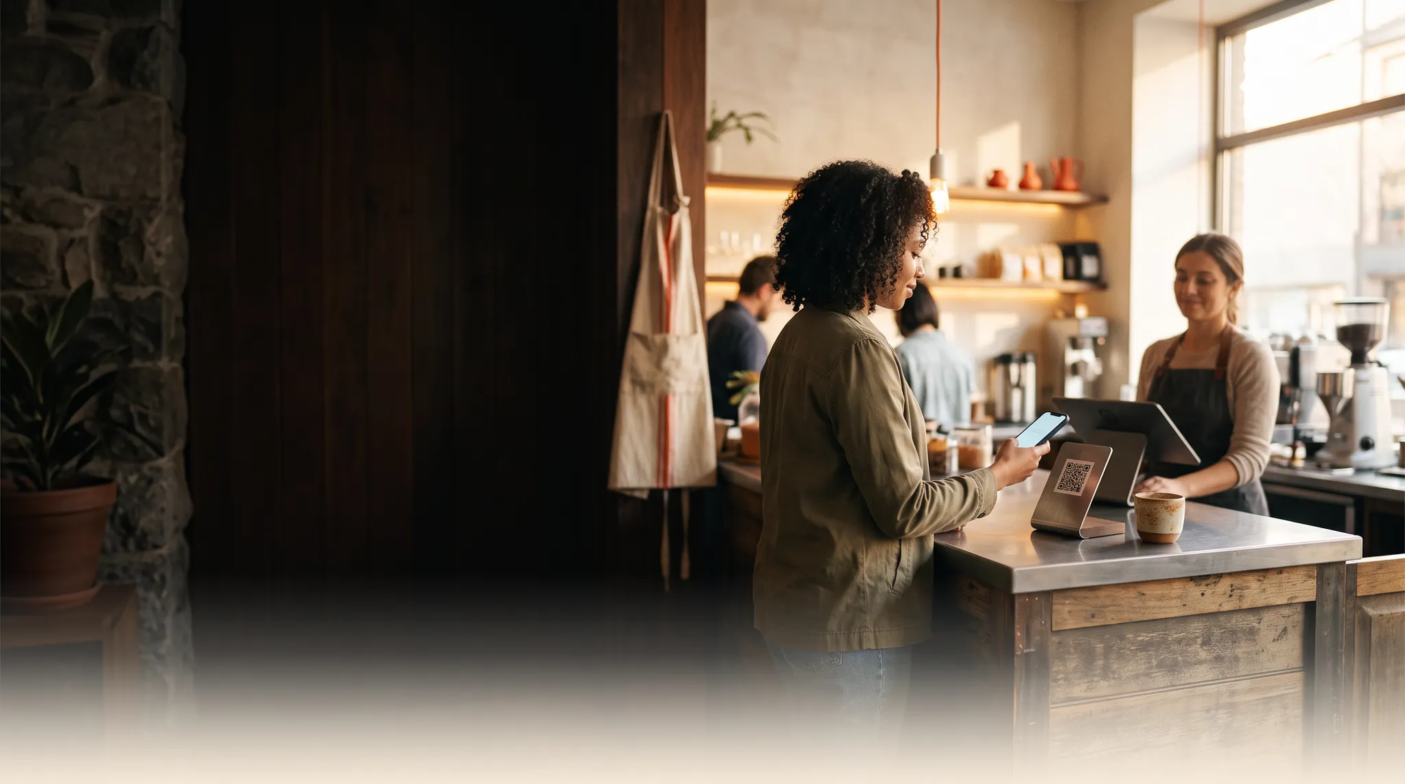 Customer using a phone at an independent cafe checkout